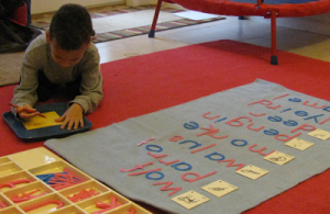 Working with the moveable alphabet is a kinetic learning experience.